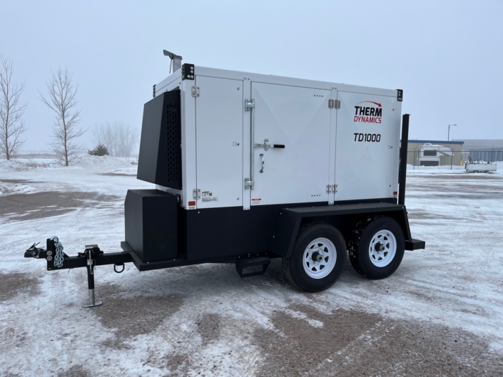 side view of the TD1000 flameless heater designed for the oil and gas industry and energy industry sitting in a parking lot in the winter