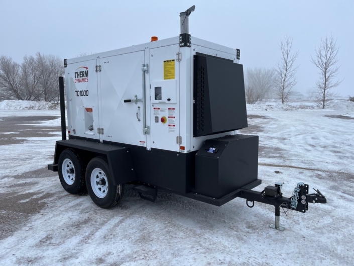 closer side view of the TD1000 flameless heater designed for the oil and gas industry and energy industry sitting in a parking lot in the winter
